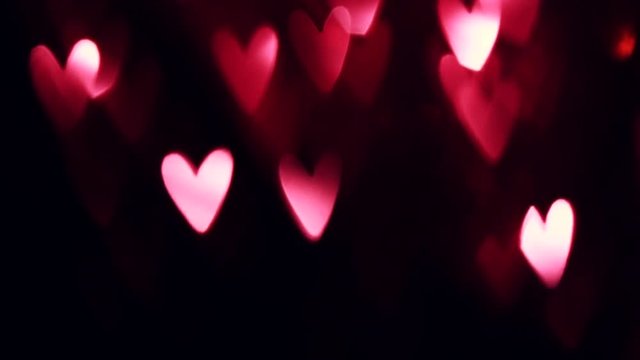 Valentine's Day background. Holiday abstract background with red glowing hearts. Slow motion 4K UHD video footage. 3840X2160