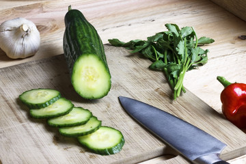 Slicing cucumber on a chopping board