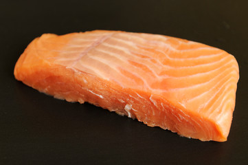 Fresh Alaskan salmon steak on a grill plate