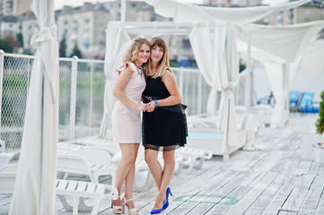 Two girls posed at hen party on the pier of beach.