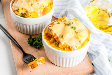 Homemade italian bread casserole strata with cheese, egg and ham, white background copy space