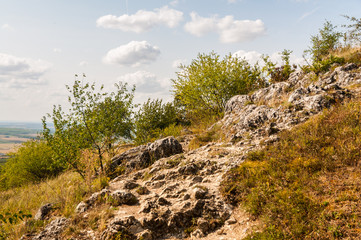 Fototapeta na wymiar boulders on the hill with blue sky and nice clouds in background