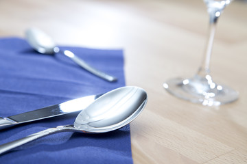 Spoon fork and knife on a blue napkin