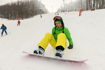 Pretty young woman on the snowboard