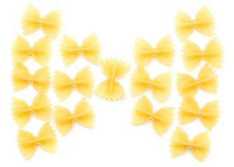 Raw farfalle folded in bow top view isolated on white background a lot of dry pasta pieces.