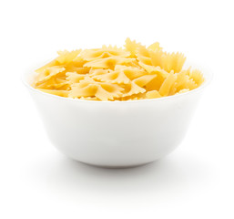 Raw farfalle in porcelain bowl isolated on white background dry pasta pieces.