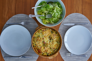 Zucchini Flan Served On a Wooden Table Dressed With Salad Bowl and Soufflenheim Pottery