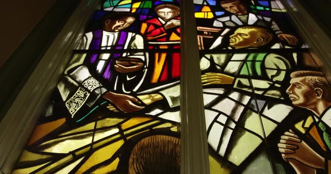 Stainglass window in church showing prayers worship