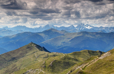 Sunny Helm Monte Elmo peak at end of Karnischer Hohenweg trail on Carnic Alps main ridge above Pustertal with snowy Hochgall Collalto peak Hohe Tauern Italian Austrian border East / South Tyrol Europe