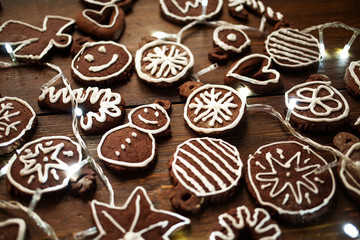 Traditional homemade Christmas ginger and chocolate cookies decorated with white sugar painting