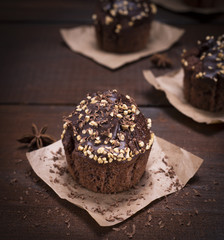 chocolate muffin sprinkled with nuts