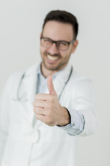 Portrait of young doctor with thumb up