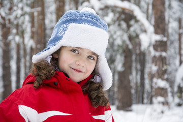 In winter, there is a little  girl in the forest.