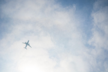 Airplane Silhouette through the Clouds