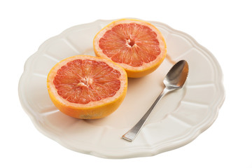 Obraz na płótnie Canvas Grapefruits on plate with spoon