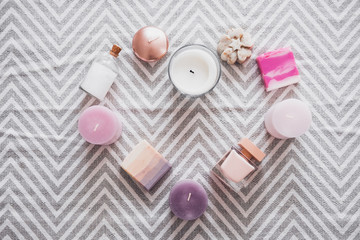 Organic spa beauty treatments in a heart shape from above on gray textured carpet. Skincare routine, valentine's day minimalist concept