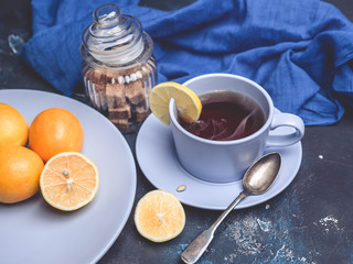 Hot tea with a lemon on a dark blue background.