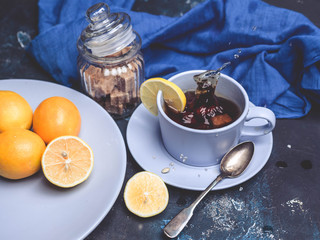 Hot tea with a lemon on a dark blue background.