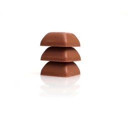 Pieces of natural chocolate isolated on white background
