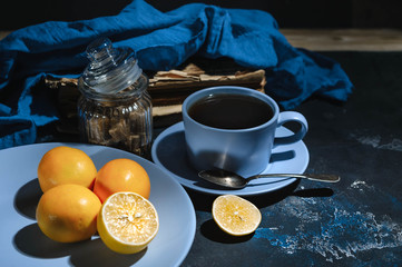 Hot tea with a lemon on a dark blue background.