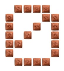 Figures from pieces of natural chocolate isolated on white background