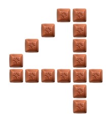 Figures from pieces of natural chocolate isolated on white background