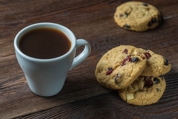 Coffee cup and cookies composition on rustic wooden background
