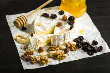 Camembert cheese with nuts, fruit and honey
