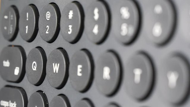 Black computer keyboard detail qwerty view closeup.