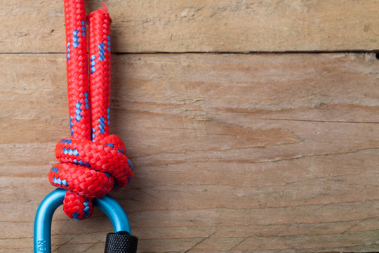 Fishermans Knot with Red Rope on Carabiner with copy space