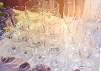 A set of glass of wedding  setting with cutlery . Table set for an event party or wedding reception. Beautiful  candles and flowers for a festive event, party or wedding reception .