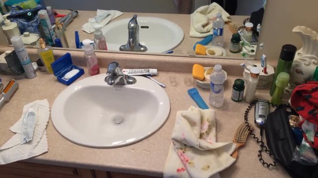 Messy Bathroom Sink Area With Supplies  In House Bathroom