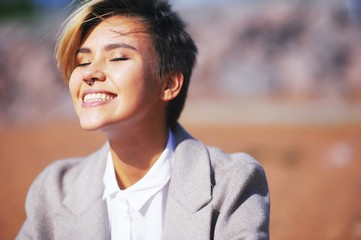 Portrait of young happy woman, fun, laughing, his eyes closed from pleasure to relax