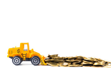 Mini bulldozer truck loading stack coin with pile of gold coin, isolated on white background with copy space, business finance and banking industrial concept. © pookpiik
