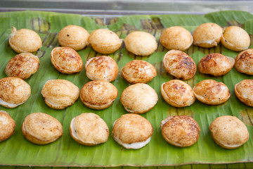 Traditional Thai bakery called Ka Nom Klok which is made from coconut milk, vegetable, herb and sugar baked in the pot.