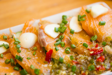 Spicy fresh sliced salmon sashimi close up.