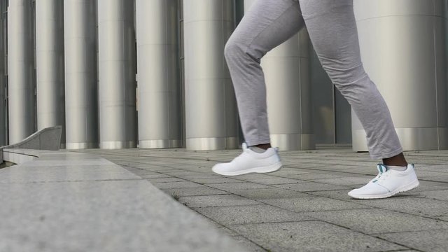 Close-up of man stretching thighs and hamstrings to decrease chance of injury