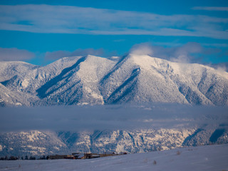 The Flathead Range of the Rocky Mountains as viewed from Rebecca Farm with some low level clouds...
