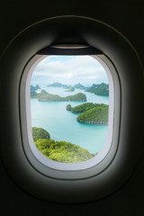 The window of airplane with travel destination attraction.