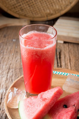 Watermelon smoothie on wood background