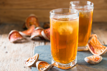 Bael juice ice tea on wooden table , healthy drink