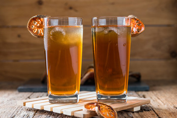 Bael juice ice tea on wooden table , healthy drink