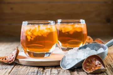 Bael juice ice tea on wooden table , healthy drink