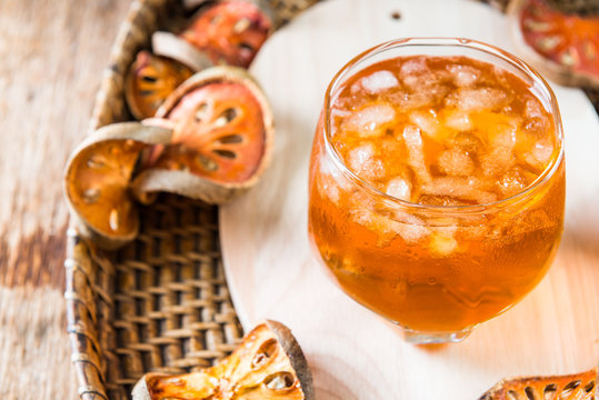Bael juice ice tea on wooden table , healthy drink
