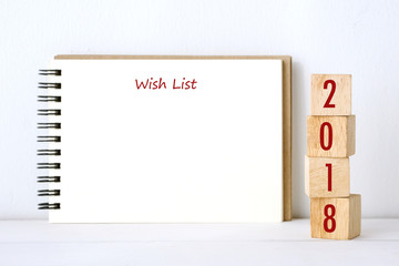 2018 wish list on blank note book paper background