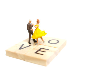 Miniature people, Couple romantic dancing on white background , Valentine's day concept