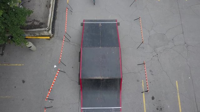 aerial bmx riders doing backflips jumps underneath drone three guys in a row 4k
