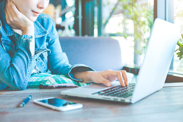 Woman hand works in a laptop computer in the office.