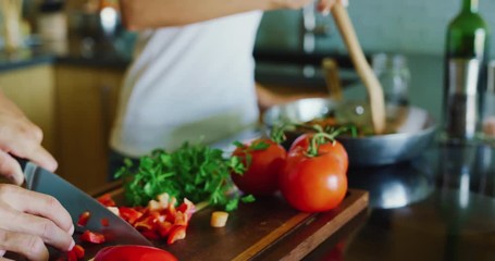 Close up of couple chopping fresh vegetables cooking in the kitchen - Powered by Adobe