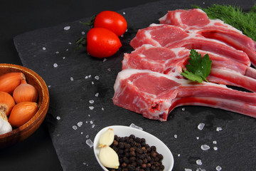 Raw Beef with Bones on the Black Background